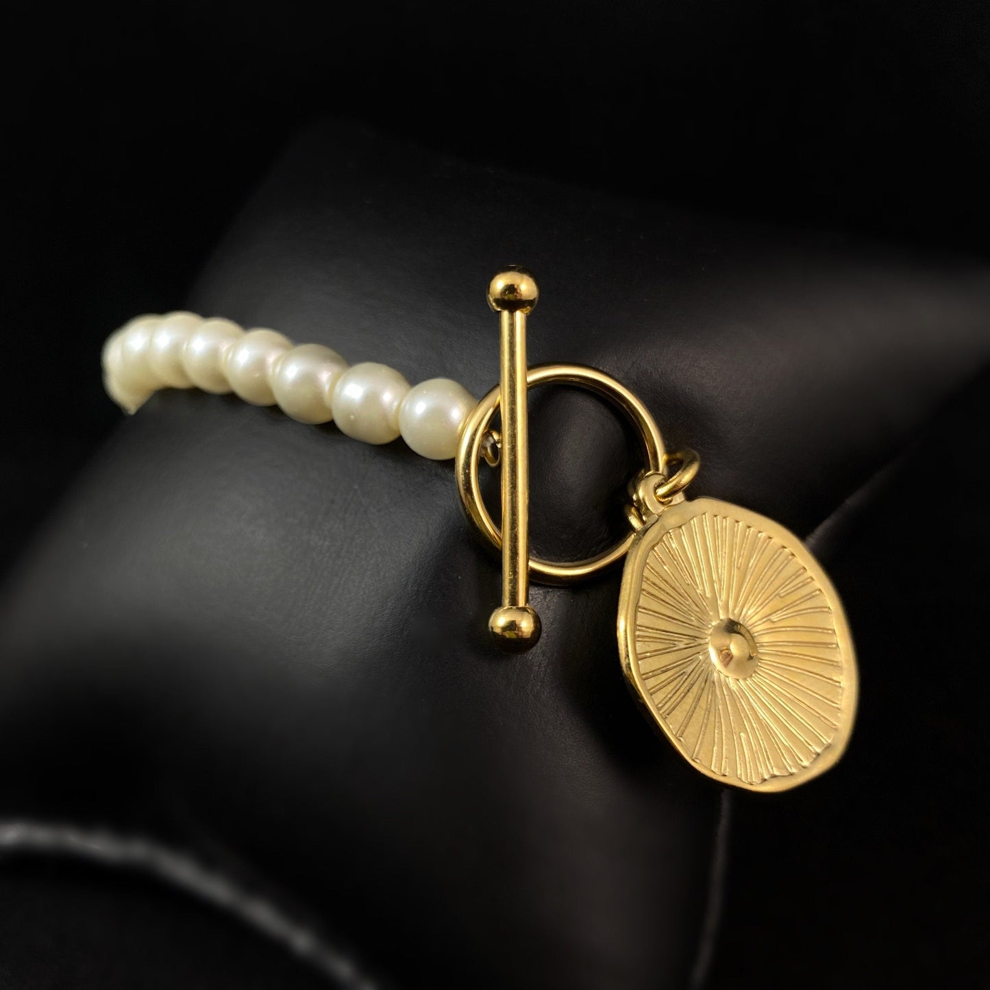 White Pearl Bracelet with Gold Orange Slice Accent, a Chunky Gold Chain, and a Decorative Toggle Clasp