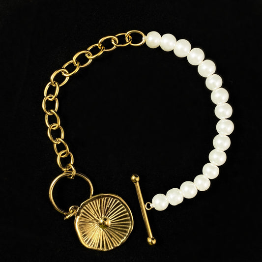 White Pearl Bracelet with Gold Orange Slice Accent, a Chunky Gold Chain, and a Decorative Toggle Clasp